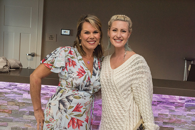 Two guests pose for a photo at United by the Vine 2019.