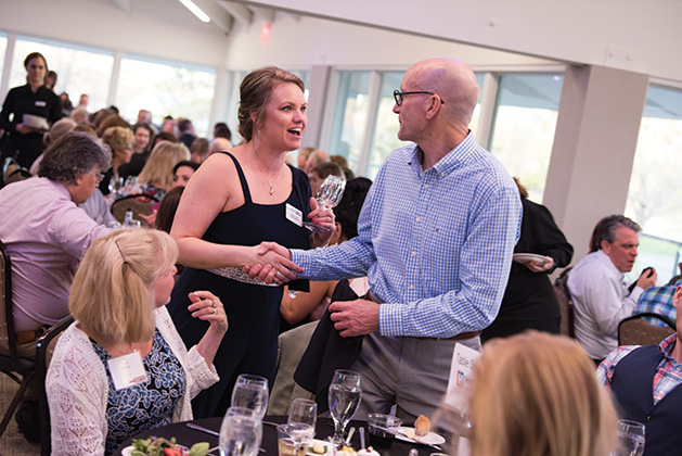 Two guests shake hands at United by the Vine 2019