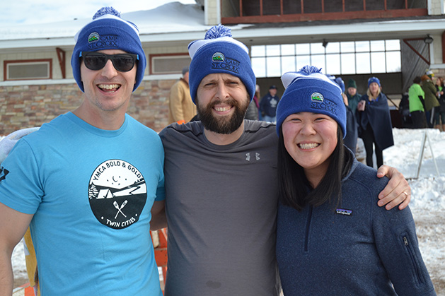 Three people pose at the St. Croix River Dunk