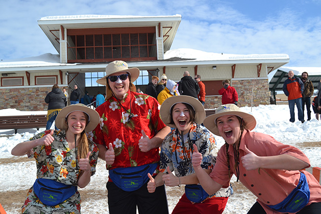 A group of people costumed as tourists pose at the St. Croix River Dunk