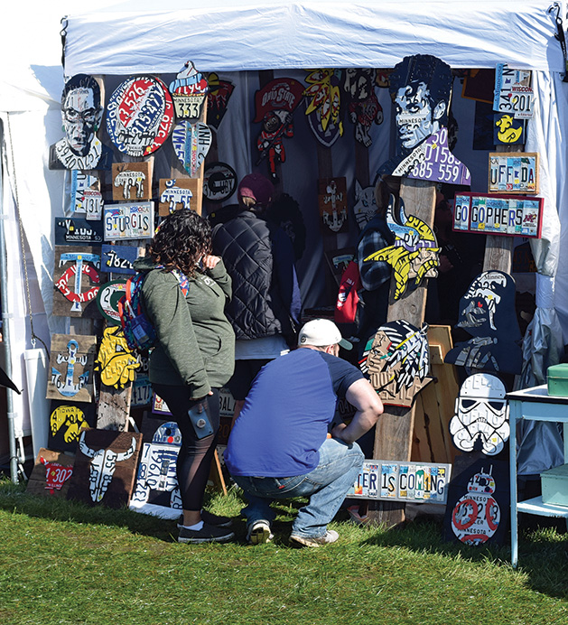 Attendees look at art at the Rivertown Fall Art Festival 2019