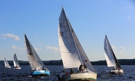 Five boats sail on the St. Croix River during a race.
