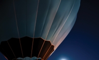 Hot air balloon illuminated by moonlight