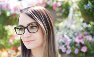 A woman models a pair of statement glasses.