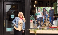 Minnesota Made Sarah Schroeder, founder of Minnesota Made apparel company, poses outside a storefront displaying some of her products