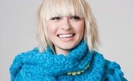 A blonde woman wearing a blue scarf.