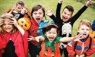 A group of kids in colorful Halloween costumes.