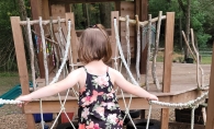 Little girl playing on the playground at HOPE Grove.