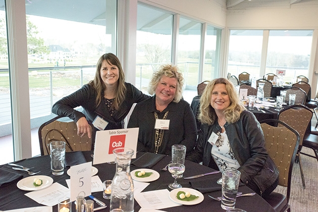 Three guests sit at a table at United by the Vine 2019