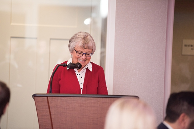 A woman speaks at the podium at United by the Vine 2019