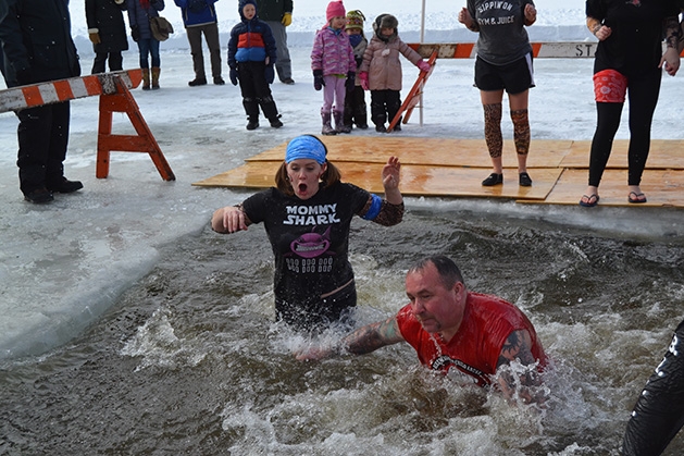 Two people jump into the water at the St. Croix River Dunk
