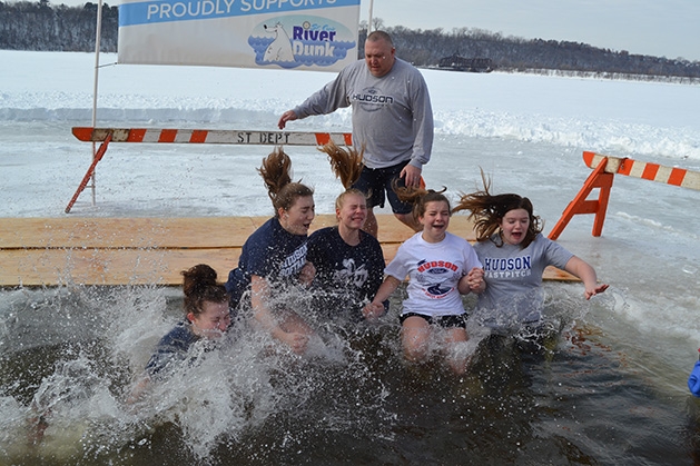 A group of girls jump into the water at the St. Croix River Dunk