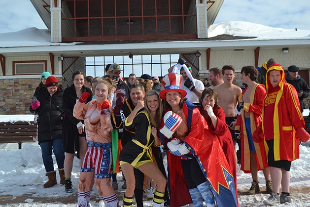 People in costumes pose for a photo at the St. Croix River Dunk