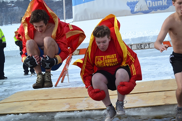 Two boys jump into the water at the St. Croix River Dunk