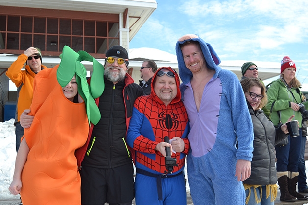 Costumed characters - including a carrot, Spider-Man and a shark - pose at the St. Croix River Dunk
