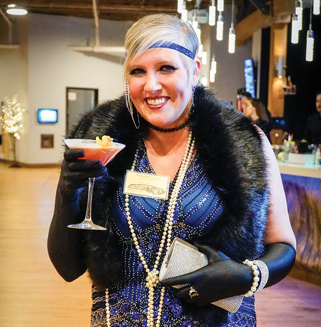 A Stillwater Chamber Gala attendee poses with a drink.
