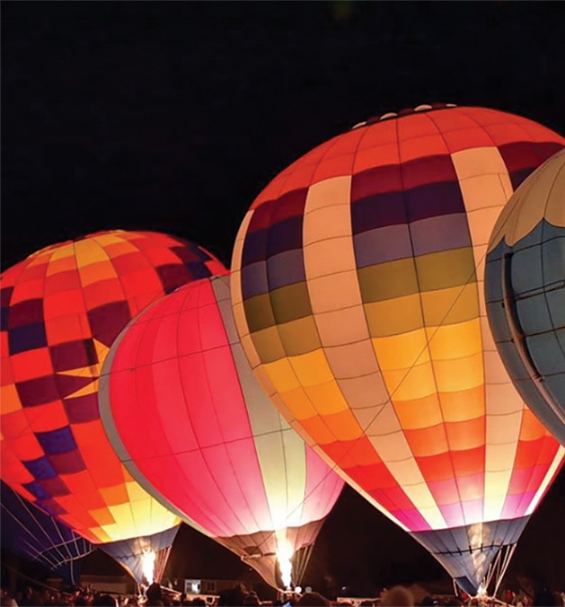 A night sky filled with hot air balloons at the Hudson Hot Air Affair 2020