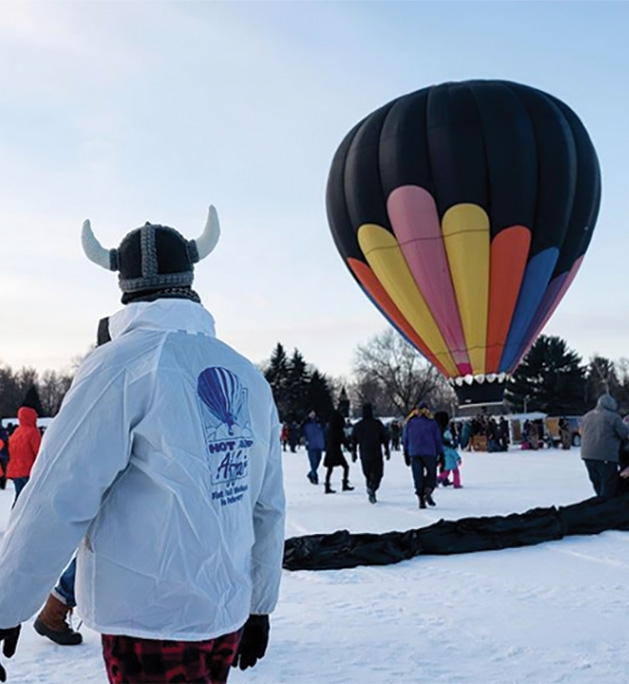 A man in a viking helmet looks on at a balloon at the Hudson Hot Air Affair 2020.