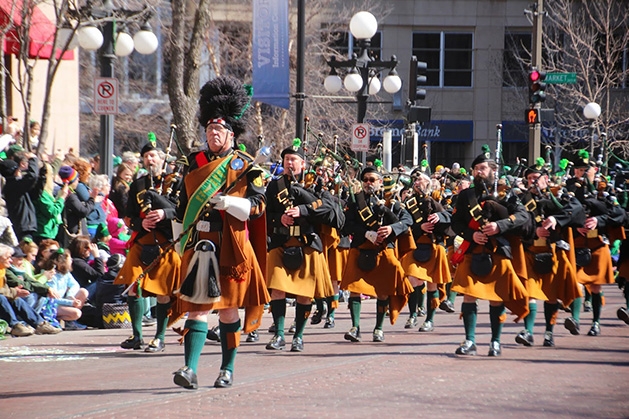 A parade marches down the street as part of The Episcopal Church of the Ascension’s Bagpipes & Bonfires event.