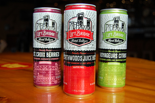 Three cans of Lift Bridge Brewing Co.'s hard seltzers - St. Croix Berries, Northwoods Juicebox and Voyageurs Citrus
