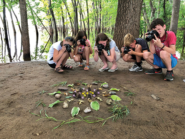 A photography class for kids at the Phipps Center for the Arts takes pictures of flowers and plants.