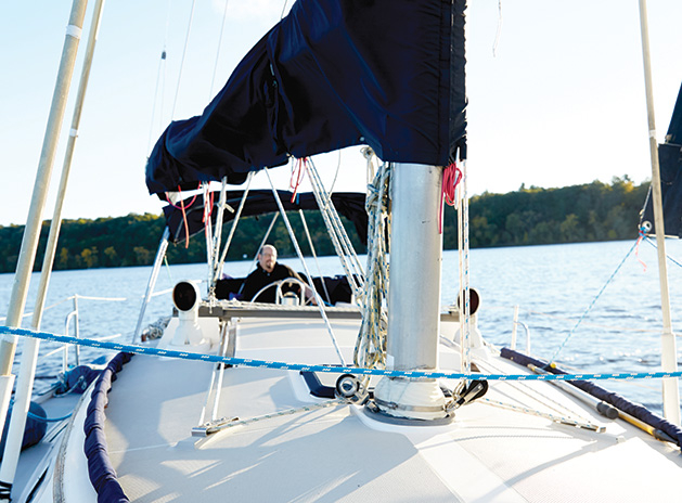 J.R. Hunter's sailboat sailing on the St. Croix River. Hunter docks the boat at Bayport Marina.