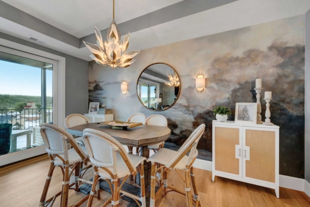 Dining room featuring a gray wall mural.