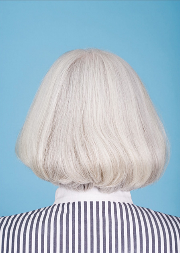 The back of a woman's head with gray hair.
