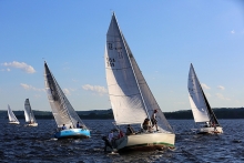 Five boats sail on the St. Croix River during a race.