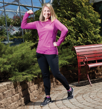 Kelly Fox, director of healthy living at the Hudson YMCA, flexes her muscles.