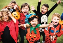 A group of kids in colorful Halloween costumes.