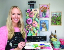 Audrey Martin poses while painting