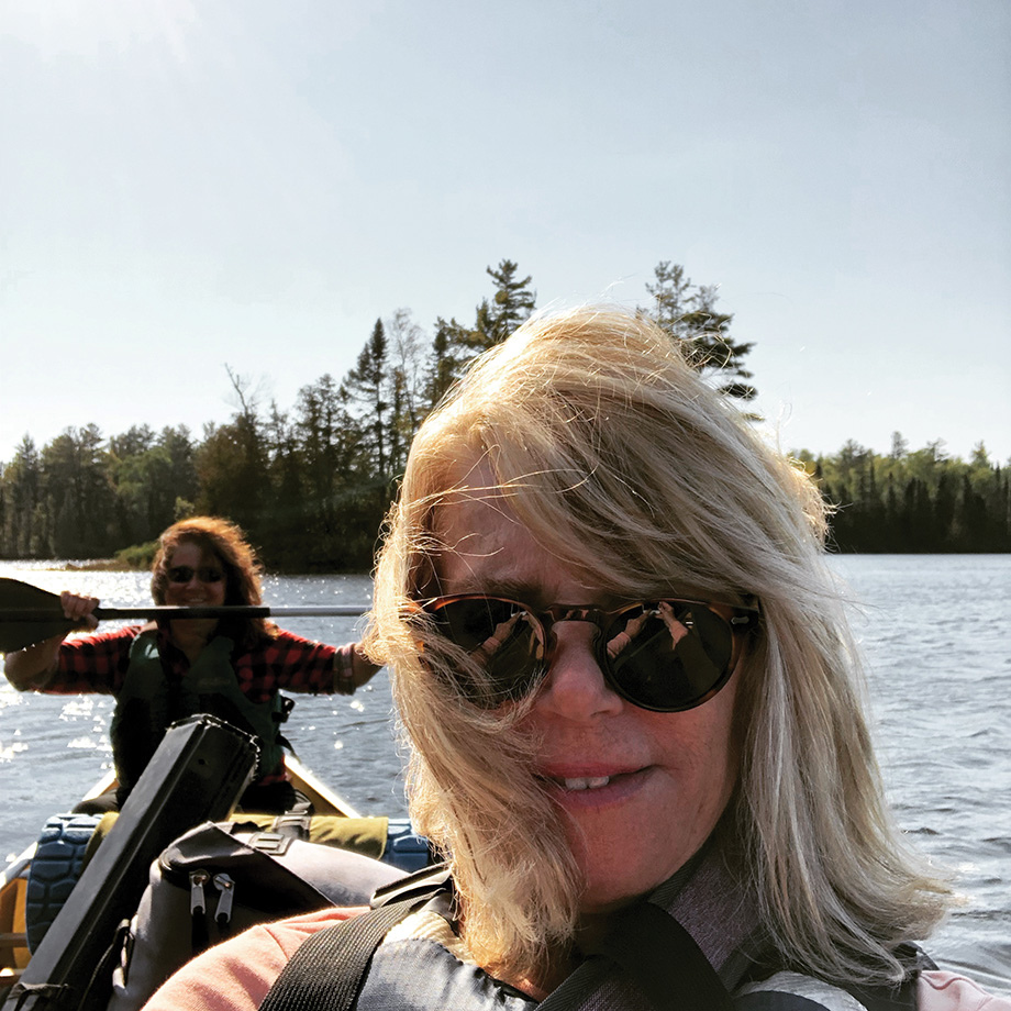 Kerri Miller canoeing with another woman.