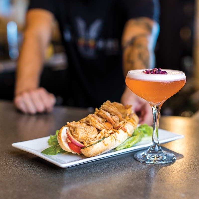 A cocktail and sandwich from The Wild Hare.