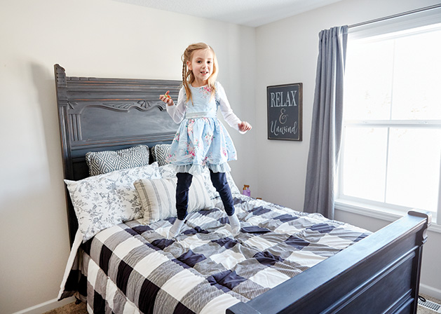 One of the Eikes' grandchildren jumps on a bed.